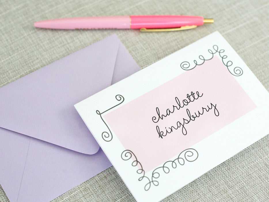 a pink pen sitting on top of an envelope