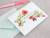 a greeting card with a pink pen on top of it