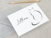 a card with a drawing of a cat on it