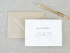 a card with a cat's face on it next to a pen
