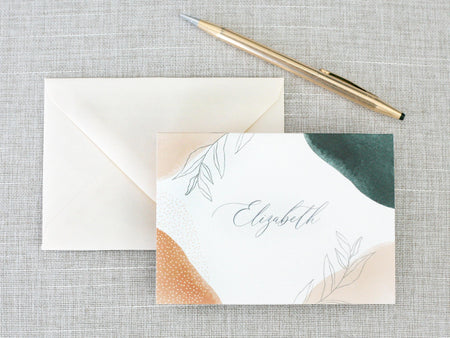 a note with a pen on top of it next to an envelope
