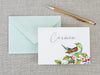 a card with a bird on it next to a pen and envelope
