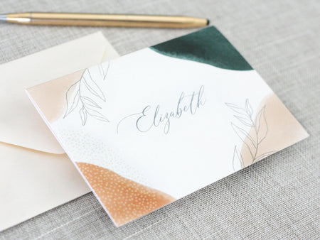 a close up of a note and a pen on a table