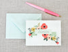 a pink pen next to an envelope with a name on it