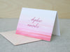 a card with a pink and red ombretta on it