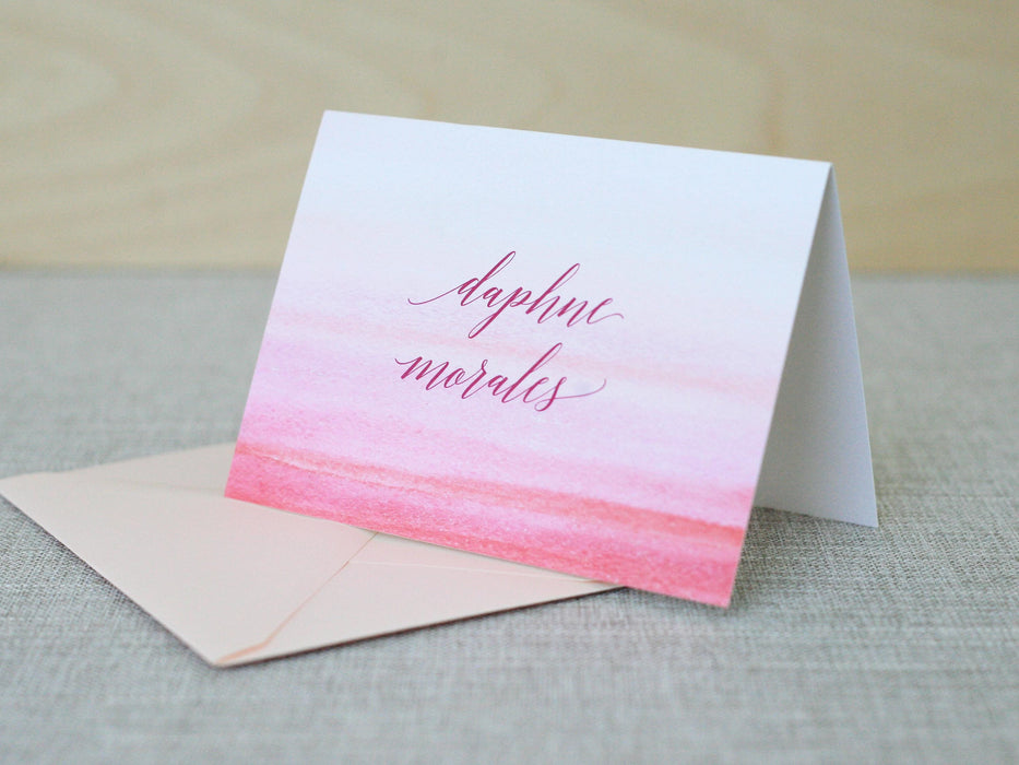 a card with a pink and red ombretta on it