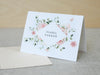 a card with a floral frame on it