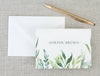 a note card with a watercolor painting of leaves