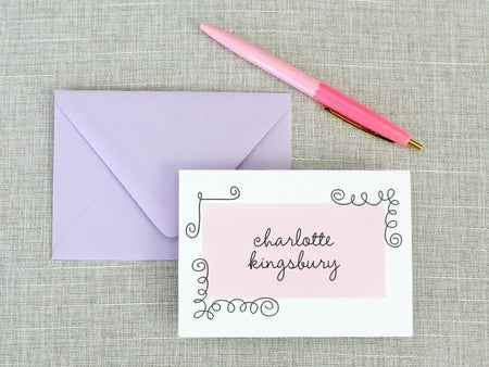 a pink pen sitting on top of an envelope