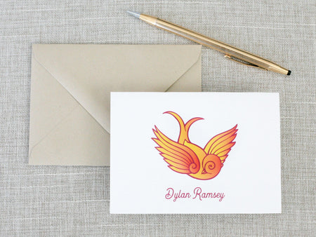 a card with a bird on it next to a pen