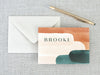 a card with the words brooke on it next to an envelope