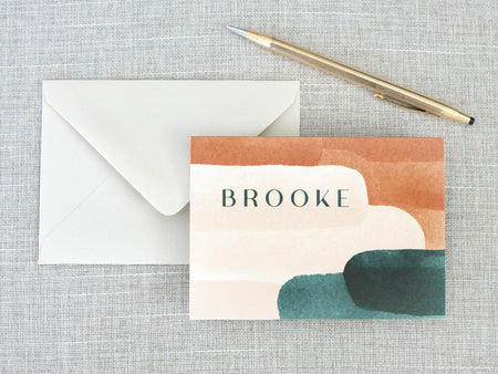 a card with the words brooke on it next to an envelope