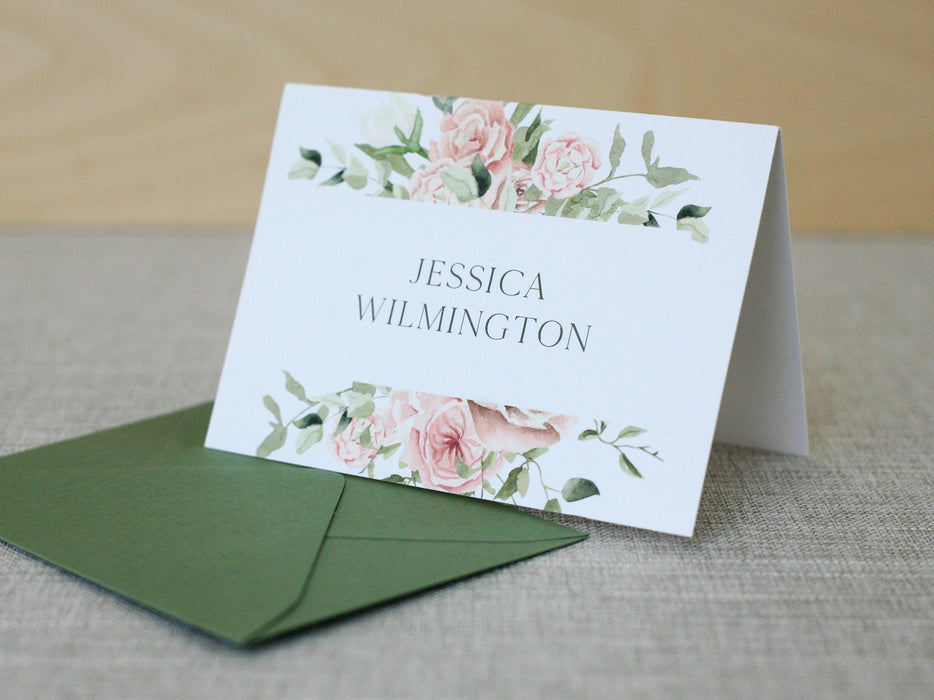 a white card with pink flowers on it