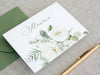 a close up of a card on a table with a pen