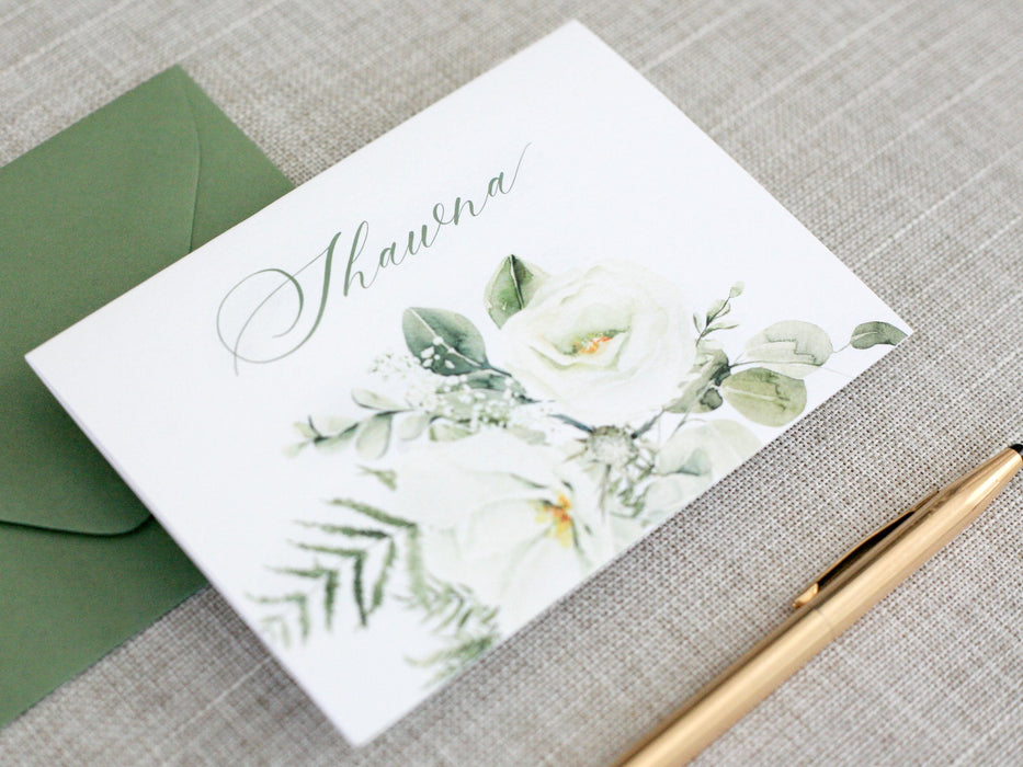 a close up of a card on a table with a pen