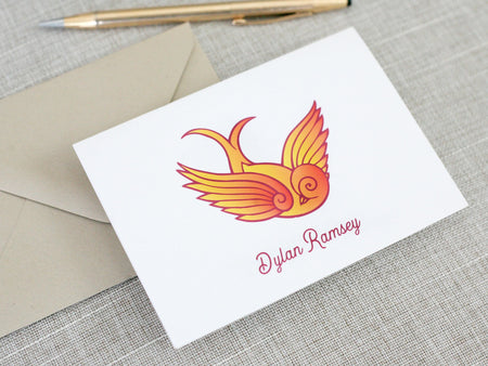 a card with a bird on it next to a pen