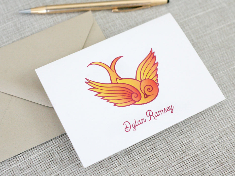 a card with a bird on it next to a pen